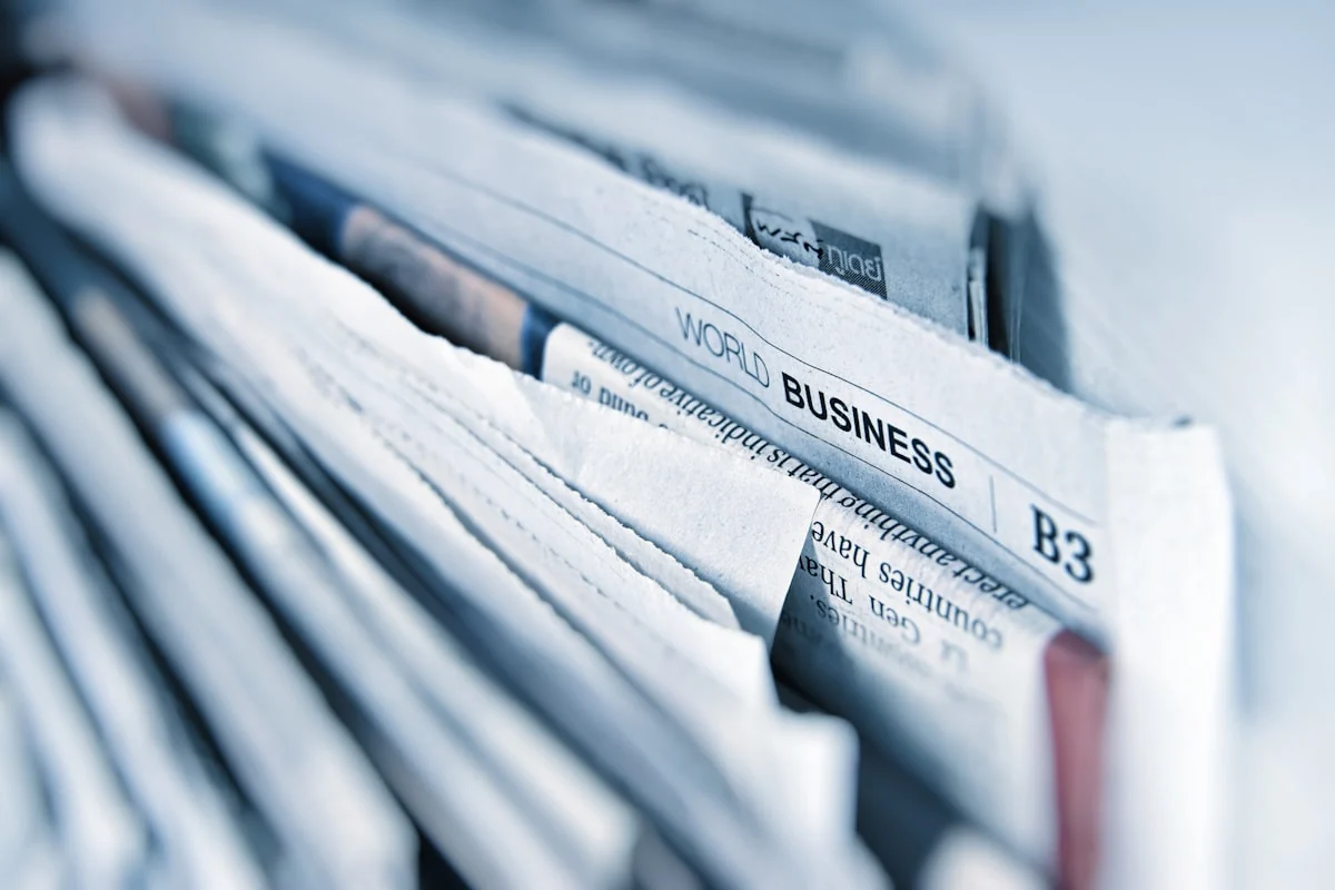 Newspapers arranged across an editorial desk